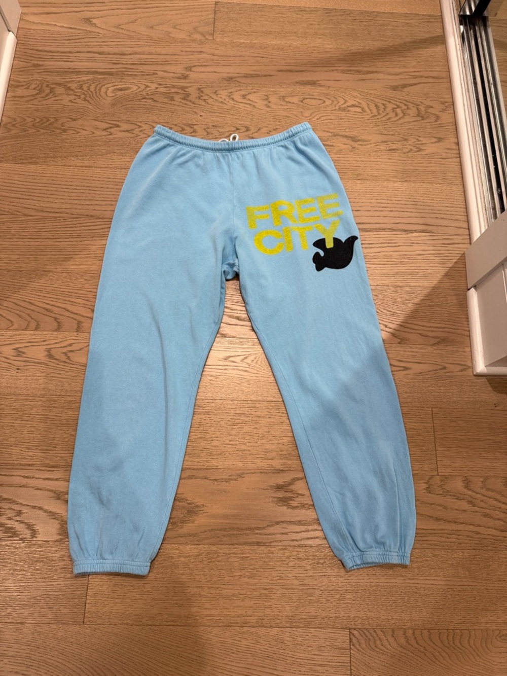 freecity Light Blue Joggers with Yellow Logo and Black Graphic